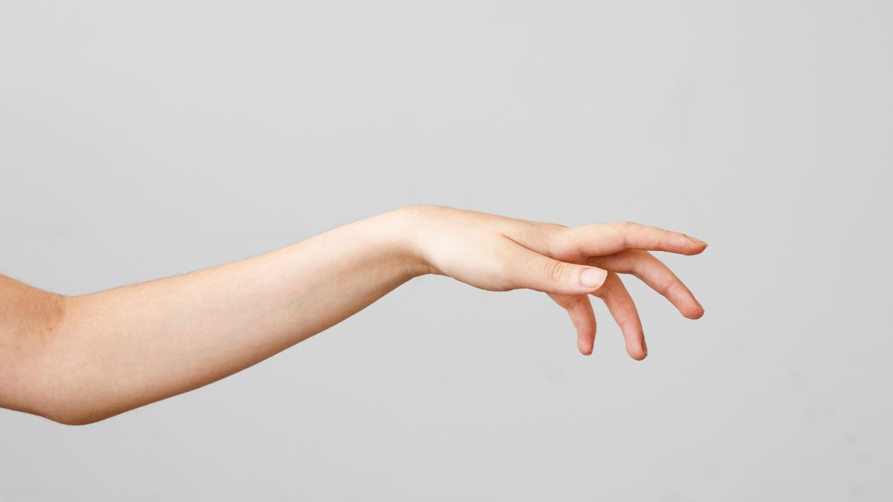 Female hand touching on gray background